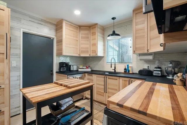 a kitchen with a wooden cabinets appliances and furniture
