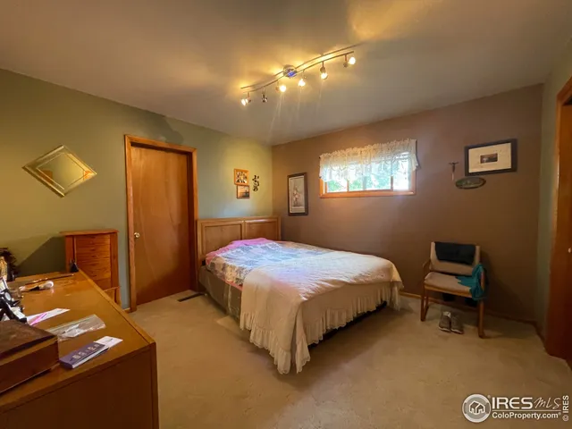 a bedroom with a bed and a lamp with window