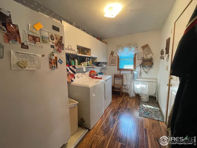a utility room with dryer washer and a view of living room