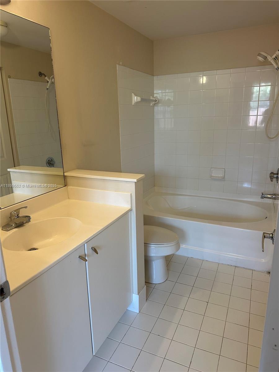 5840 West Sample Road, Unit 306 Coral Springs, FL 33067 - Photo 12 of 22 a bathroom with a sink a toilet and a bathtub