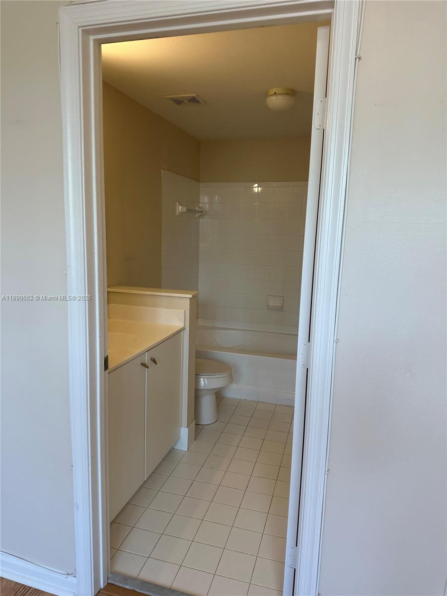 5840 West Sample Road, Unit 306 Coral Springs, FL 33067 - Photo 13 of 22 a bathroom with a sink a toilet and shower