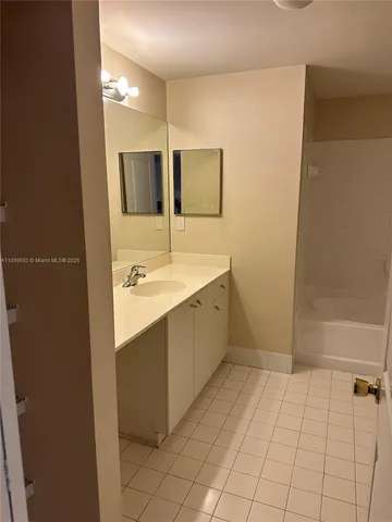 a bathroom with a sink a mirror and a bathtub