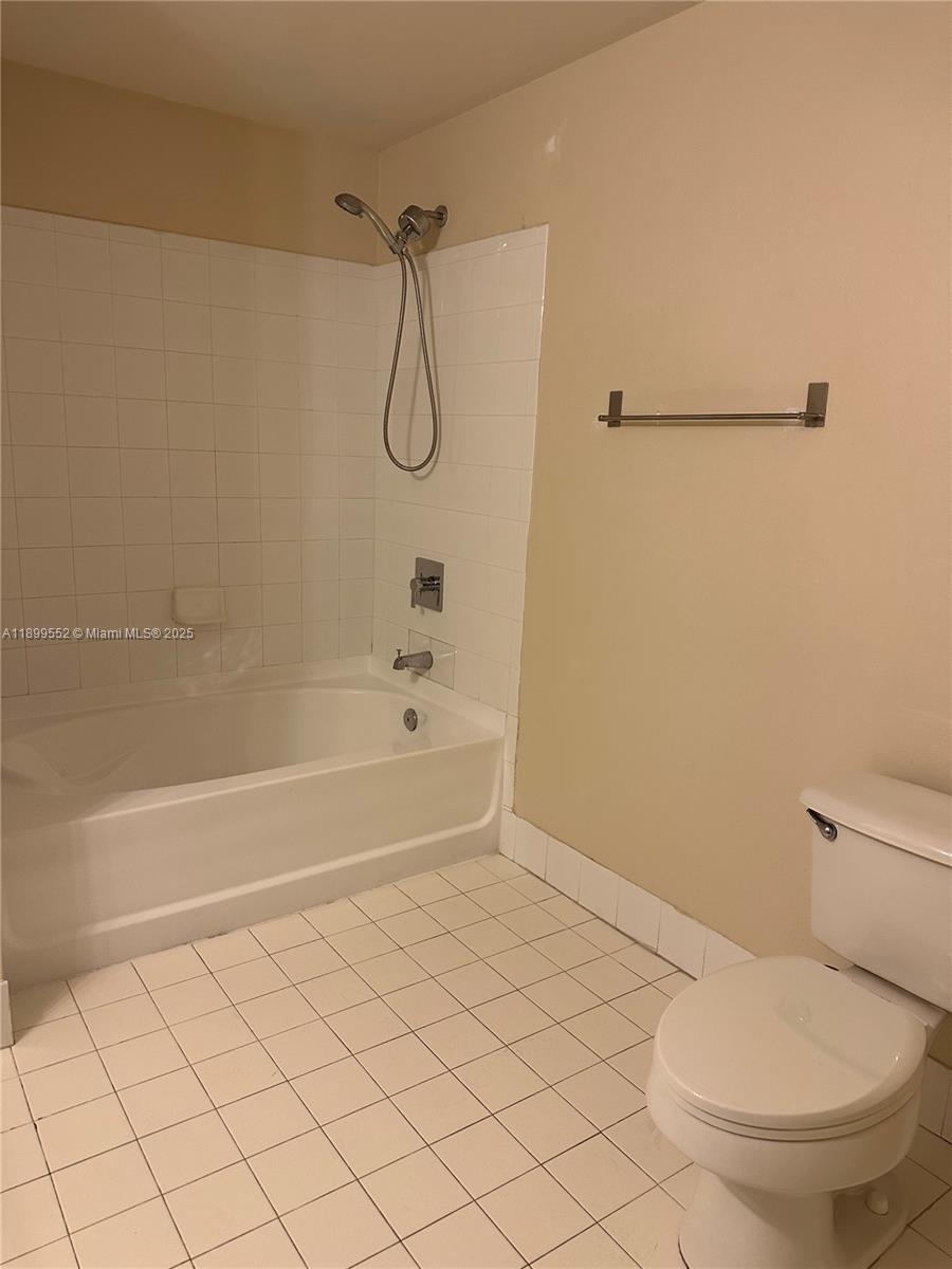 5840 West Sample Road, Unit 306 Coral Springs, FL 33067 - Photo 17 of 22 a bathroom with a toilet and a shower
