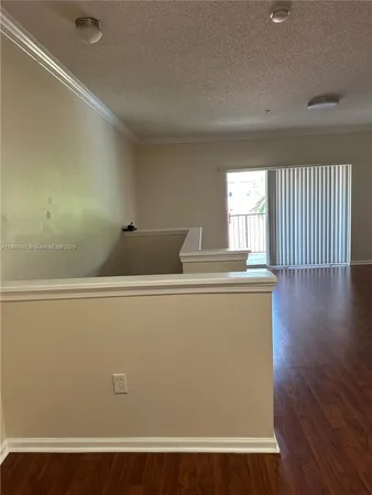 a view of wooden floor and windows in a room