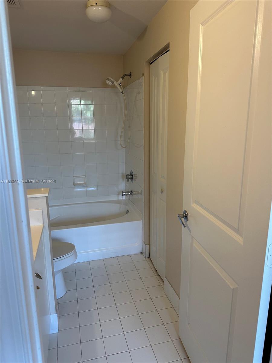 5840 West Sample Road, Unit 306 Coral Springs, FL 33067 - Photo 8 of 22 a bathroom with a bathtub and a shower