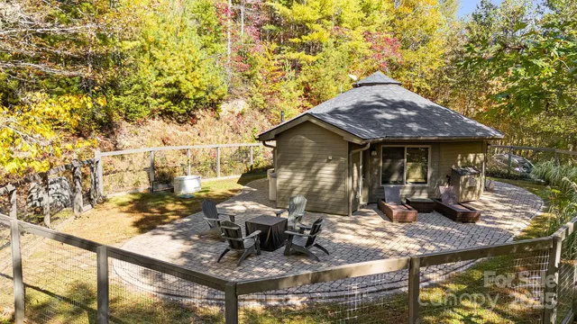a view of a house with backyard tub and sitting area