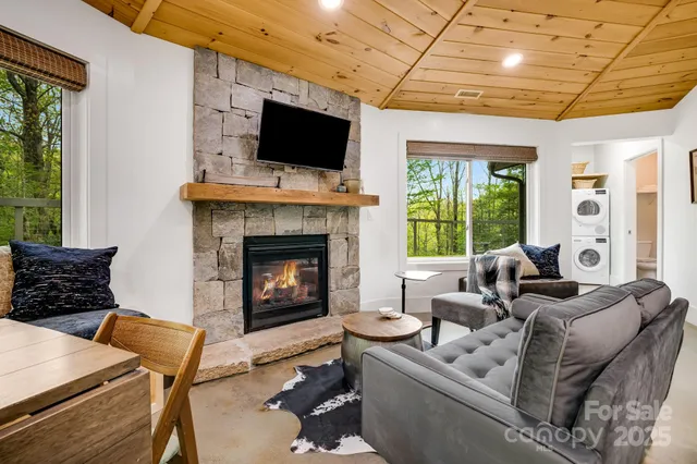 a living room with furniture a flat screen tv and a fireplace