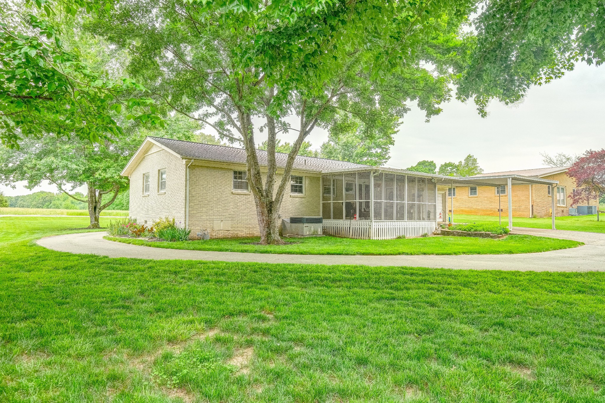 908 Fall River Road Lawrenceburg, TN 38464 - Photo 20 of 22 a view of a house with a big yard and large trees