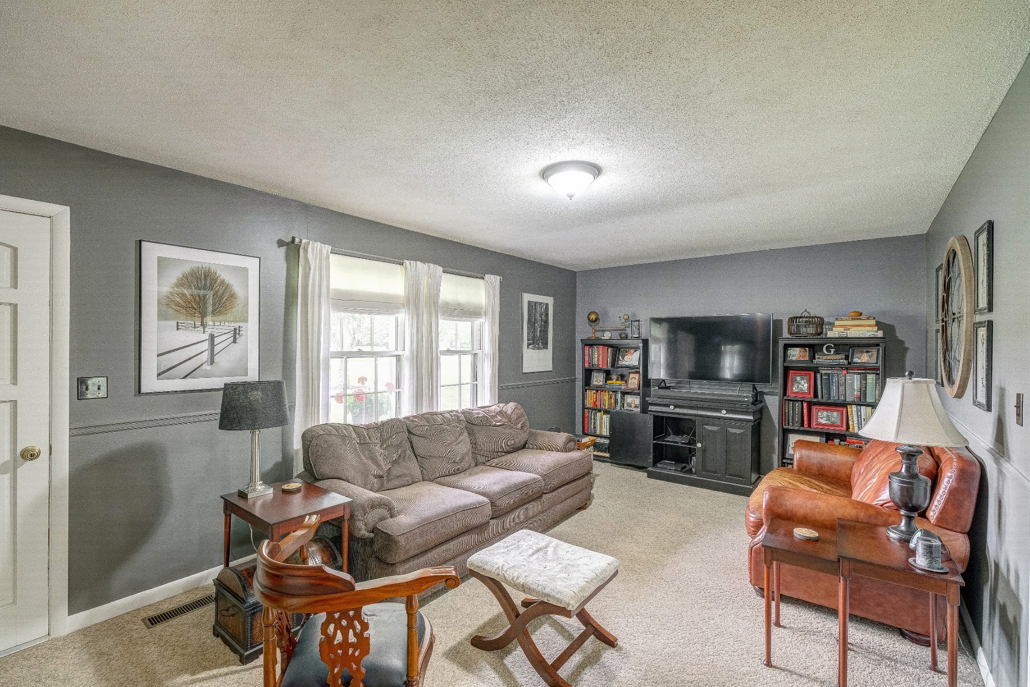 908 Fall River Road Lawrenceburg, TN 38464 - Photo 3 of 22 a living room with furniture and a flat screen tv