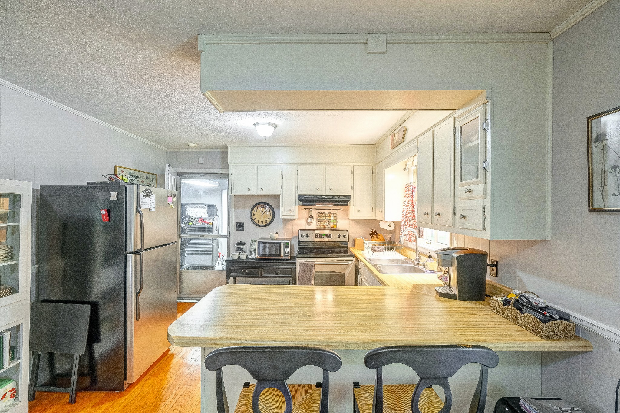 908 Fall River Road Lawrenceburg, TN 38464 - Photo 6 of 22 a kitchen with a table chairs and refrigerator