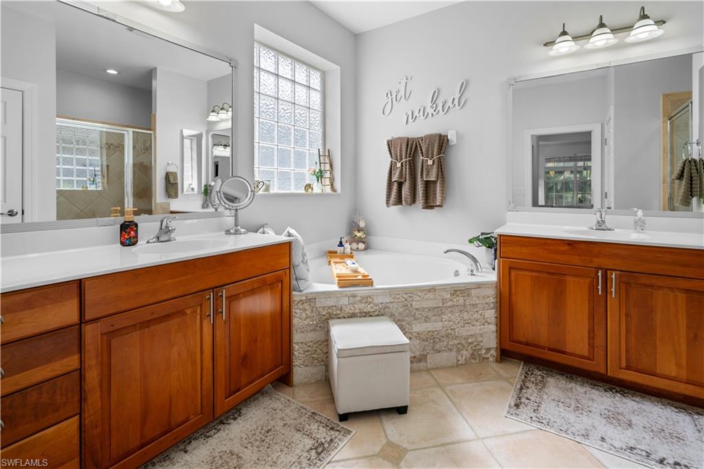 15917 Delasol Lane Naples, FL 34110 - Photo 14 of 32 a spacious bathroom with a granite countertop sink and a mirror