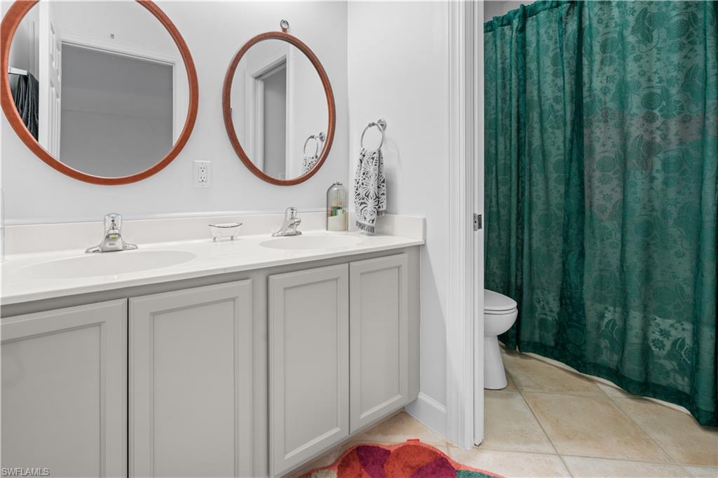 15917 Delasol Lane Naples, FL 34110 - Photo 22 of 32 a bathroom with a sink and a mirror