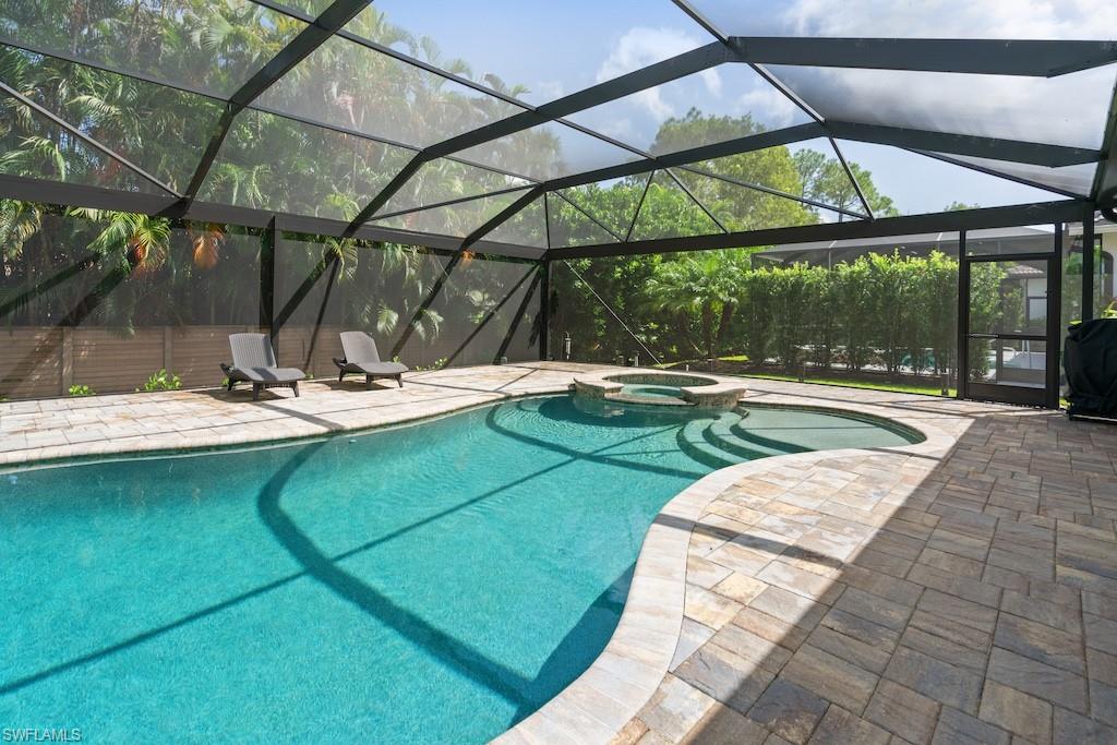 15917 Delasol Lane Naples, FL 34110 - Photo 24 of 32 a view of swimming pool with a patio and wooden fence