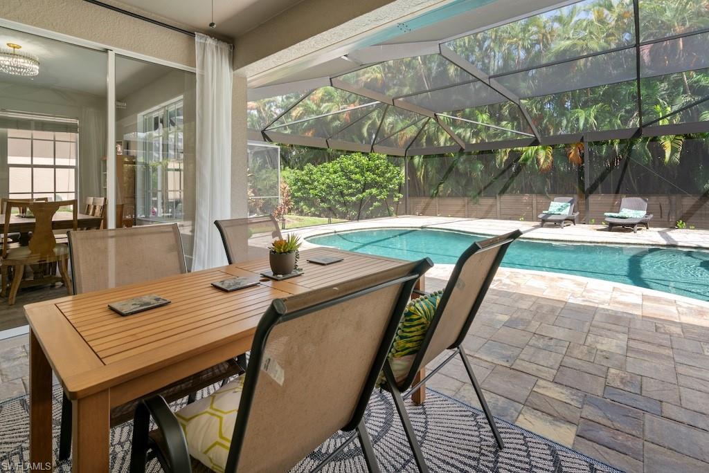 15917 Delasol Lane Naples, FL 34110 - Photo 26 of 32 a outdoor dining space with furniture and wooden floor