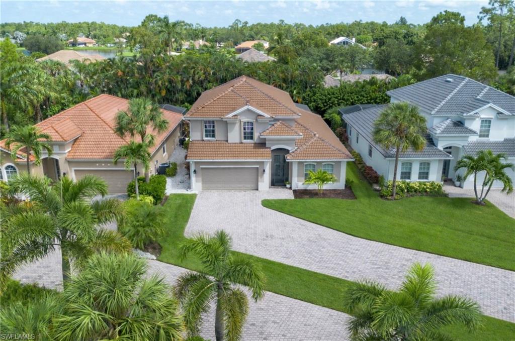 15917 Delasol Lane Naples, FL 34110 - Photo 28 of 32 an aerial view of a house with a big yard plants and large trees