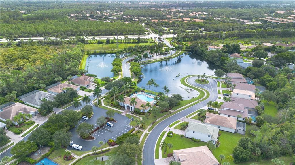 15917 Delasol Lane Naples, FL 34110 - Photo 29 of 32 an aerial view of residential houses with outdoor space and river