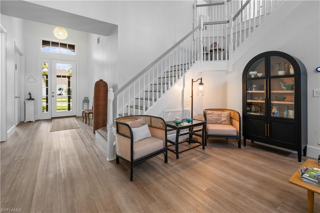 15917 Delasol Lane Naples, FL 34110 - Photo 5 of 32 a living room with furniture and a wooden floor