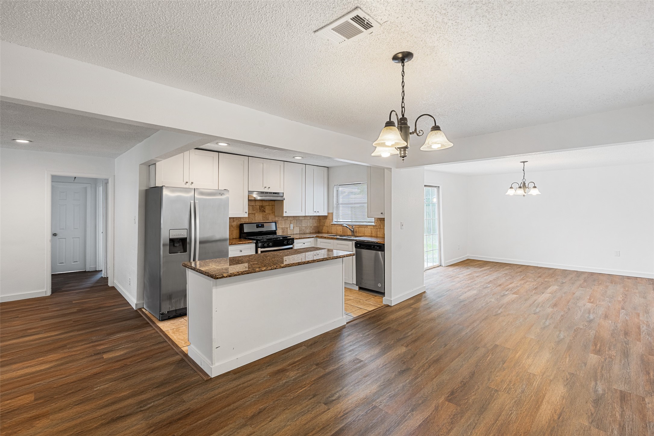9005 Gabriel Street Houston, TX 77063 - Photo 1 of 21 a kitchen with stainless steel appliances granite countertop a refrigerator a stove a sink dishwasher and a oven with wooden floors