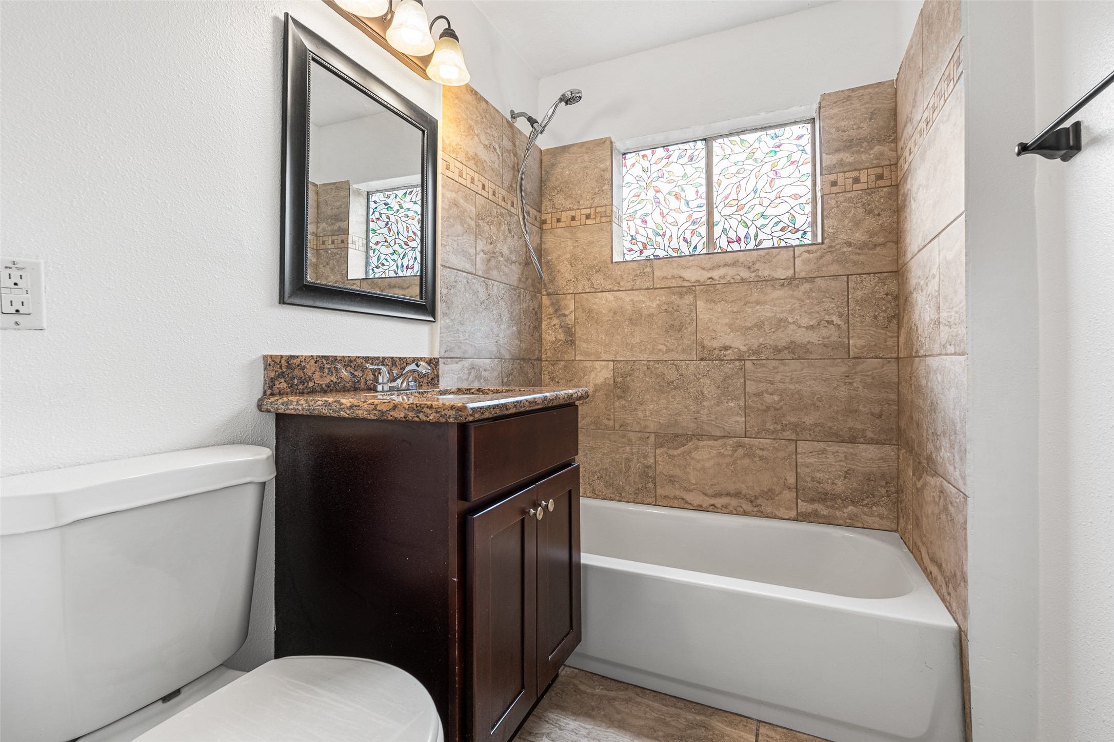 9005 Gabriel Street Houston, TX 77063 - Photo 14 of 21 a bathroom with a granite countertop sink toilet and bathtub