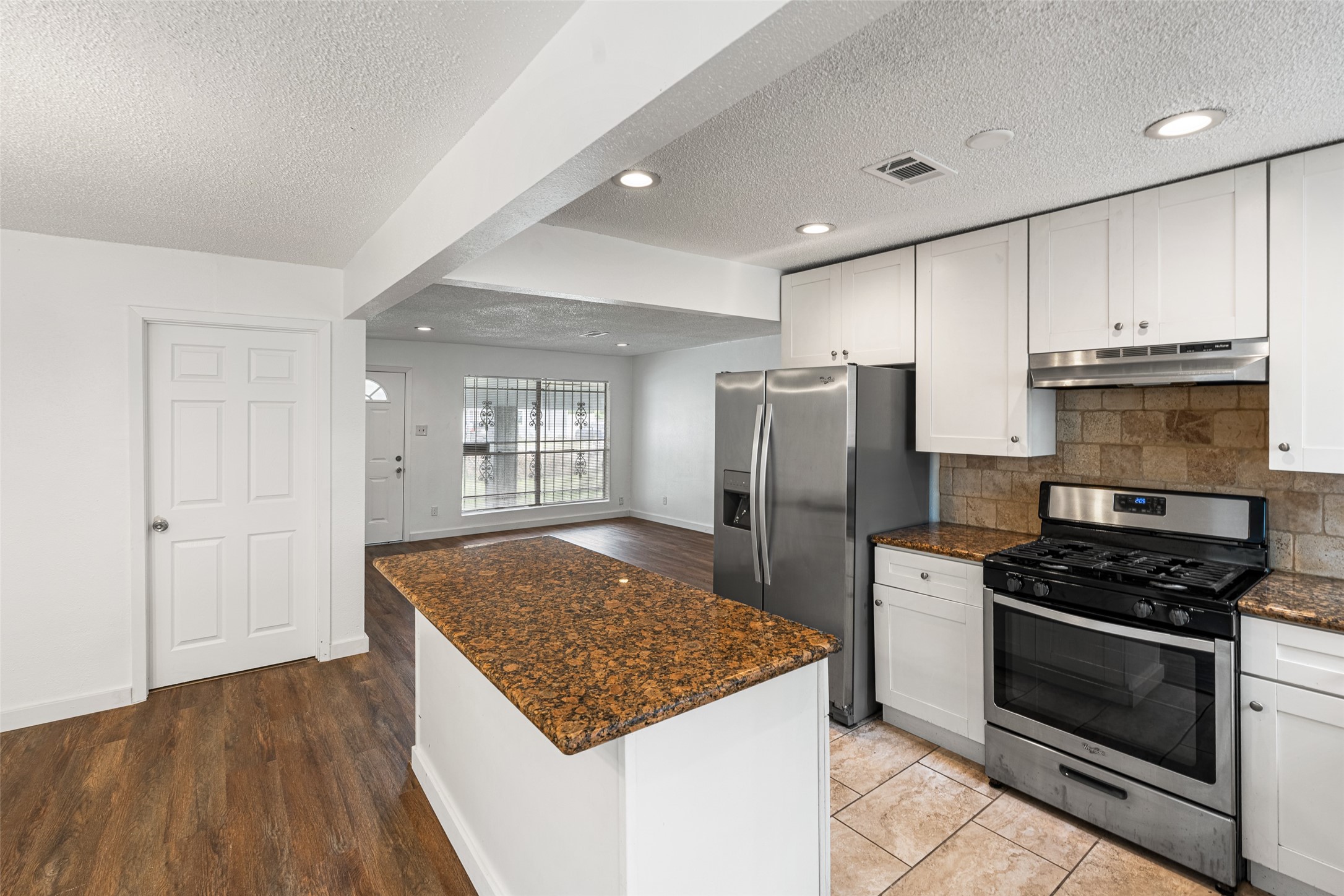 9005 Gabriel Street Houston, TX 77063 - Photo 5 of 21 a kitchen with stainless steel appliances granite countertop a stove and a refrigerator