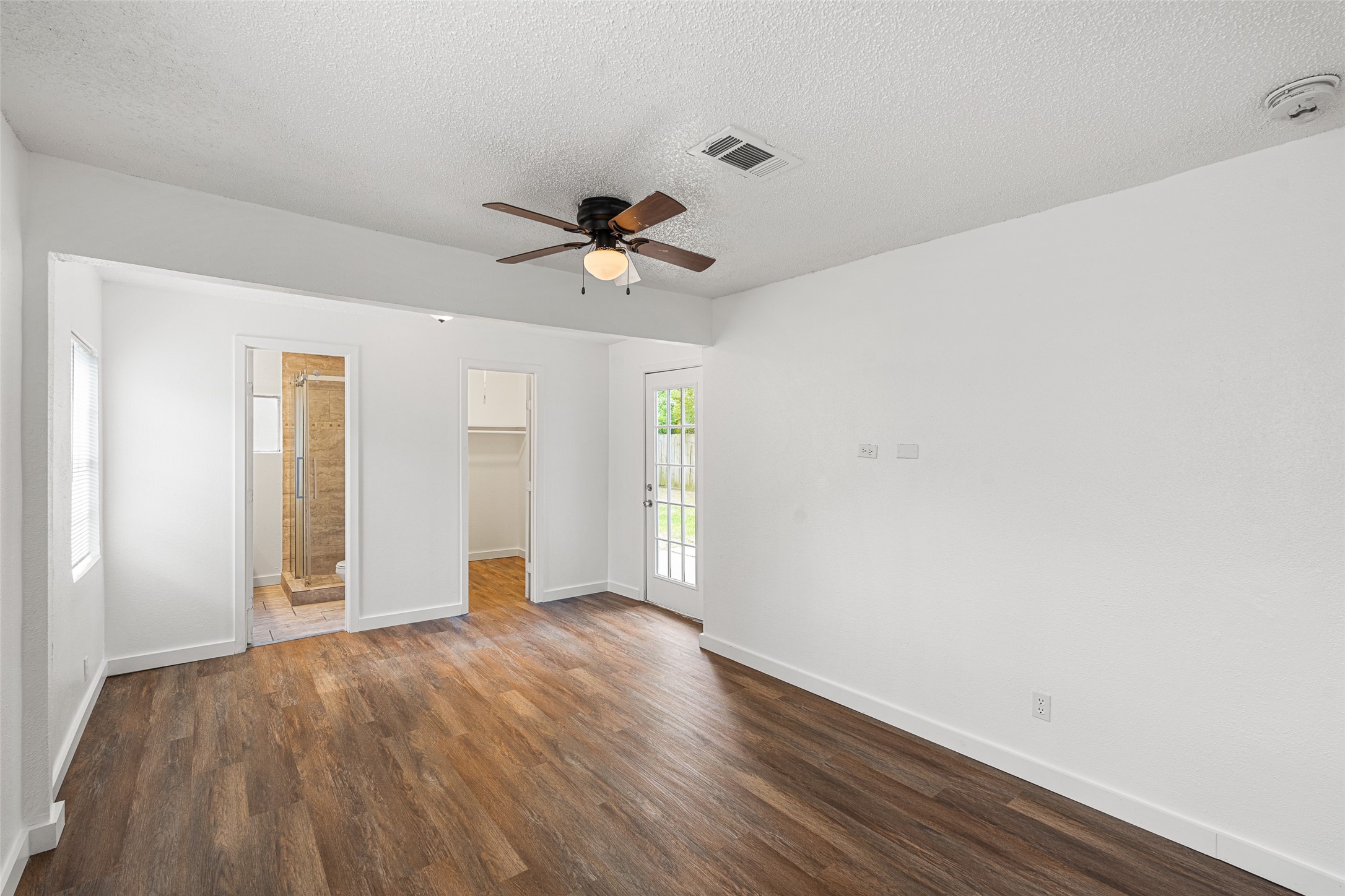 9005 Gabriel Street Houston, TX 77063 - Photo 7 of 21 a view of an empty room with window and wooden floor