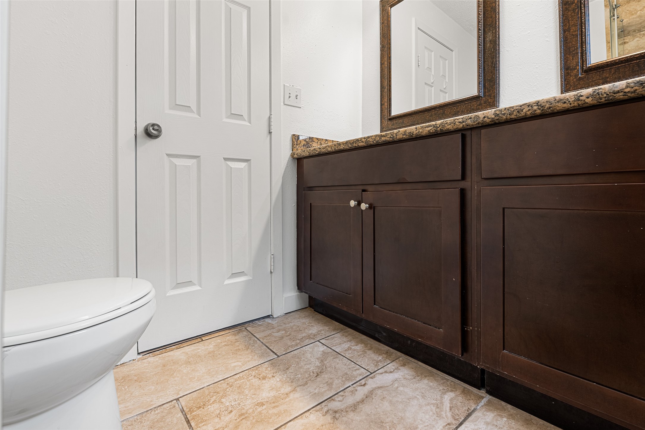 9005 Gabriel Street Houston, TX 77063 - Photo 10 of 21 a bathroom with a granite countertop sink and a toilet