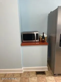 a large bed sitting in a room next to a window