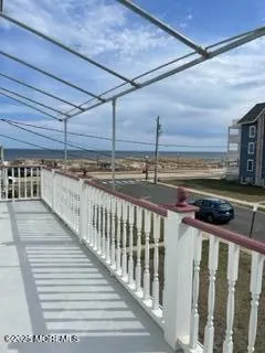 a spacious bedroom with a large bed and a chandelier