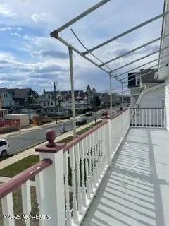 a large bed sitting in a bedroom next to a window