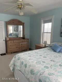 a white toilet sitting next to a window in a bathroom