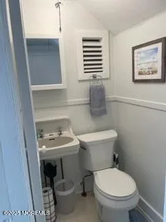 a bathroom with a toilet and a sink