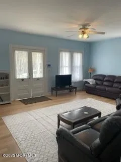 a living room with furniture and a chandelier