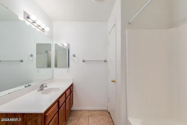 an empty room with a ceiling fan and carpet