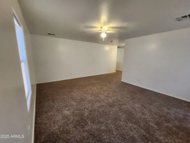 en empty room with windows and yard