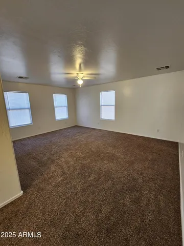 an empty room with closet and windows