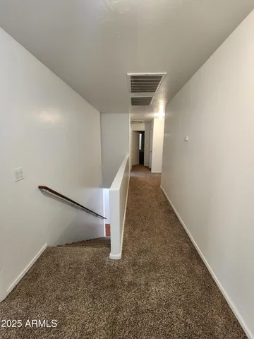 an empty room with a empty space and windows