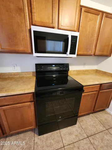 a kitchen with a sink a microwave and cabinets