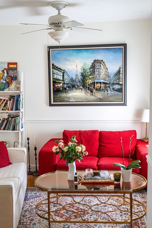 a living room with furniture and a wall painting