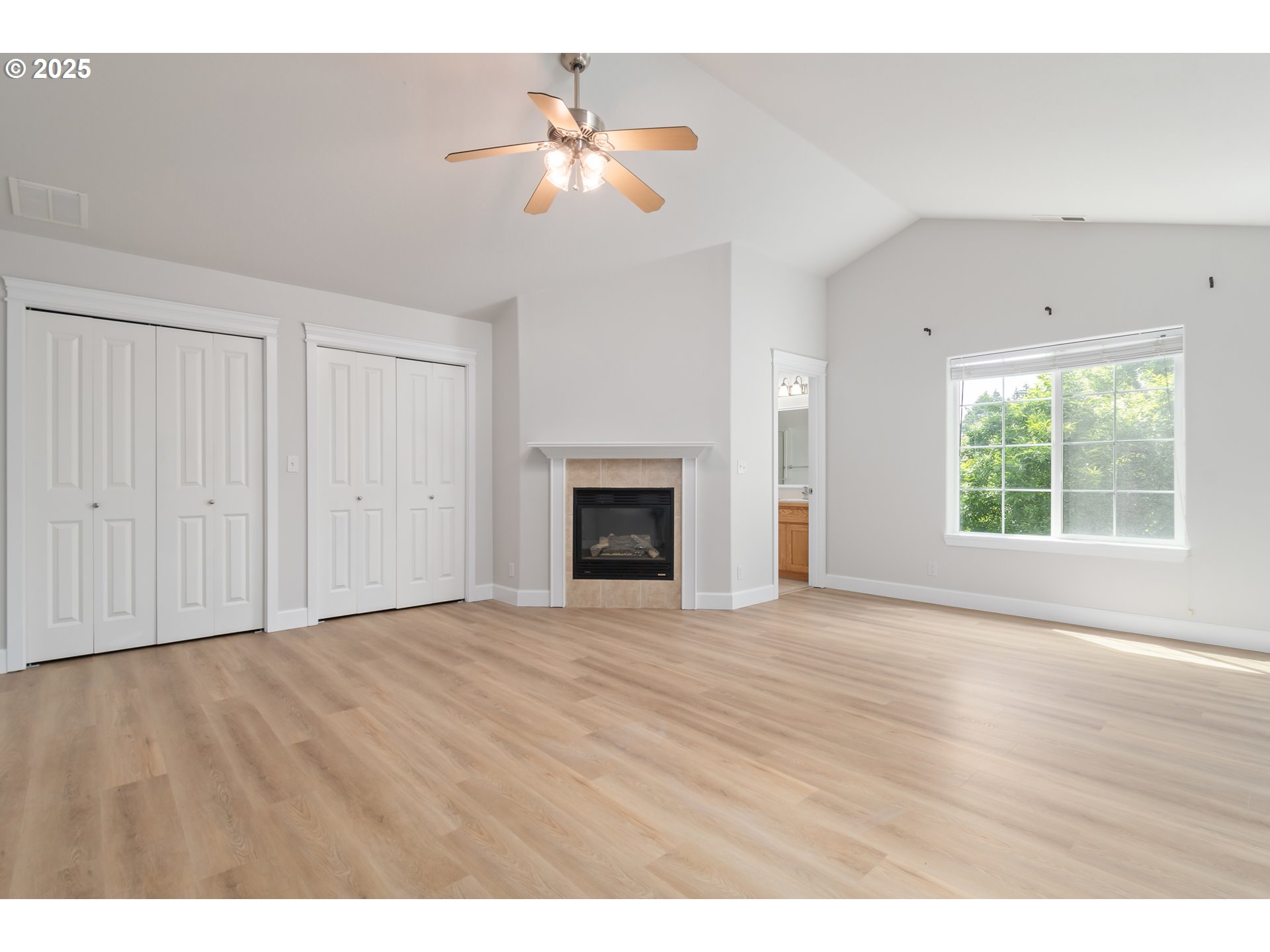 2795 Mallory Lane Eugene, OR 97401 - Photo 19 of 44 a view of an empty room with a fireplace and a window