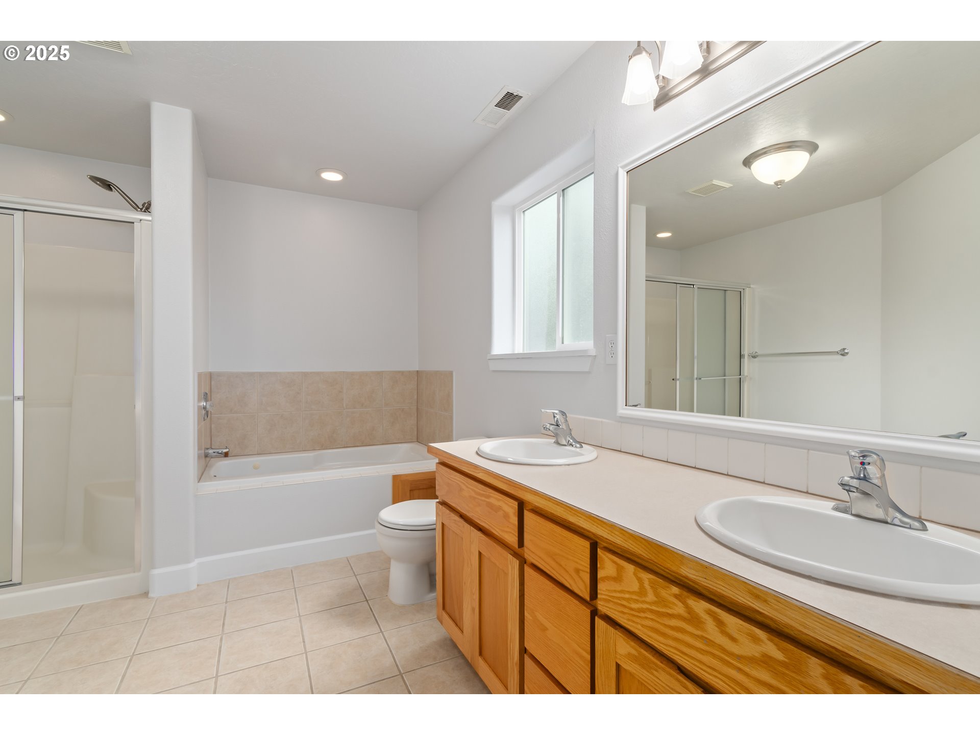 2795 Mallory Lane Eugene, OR 97401 - Photo 21 of 44 a bathroom with a granite countertop sink a toilet a mirror and shower