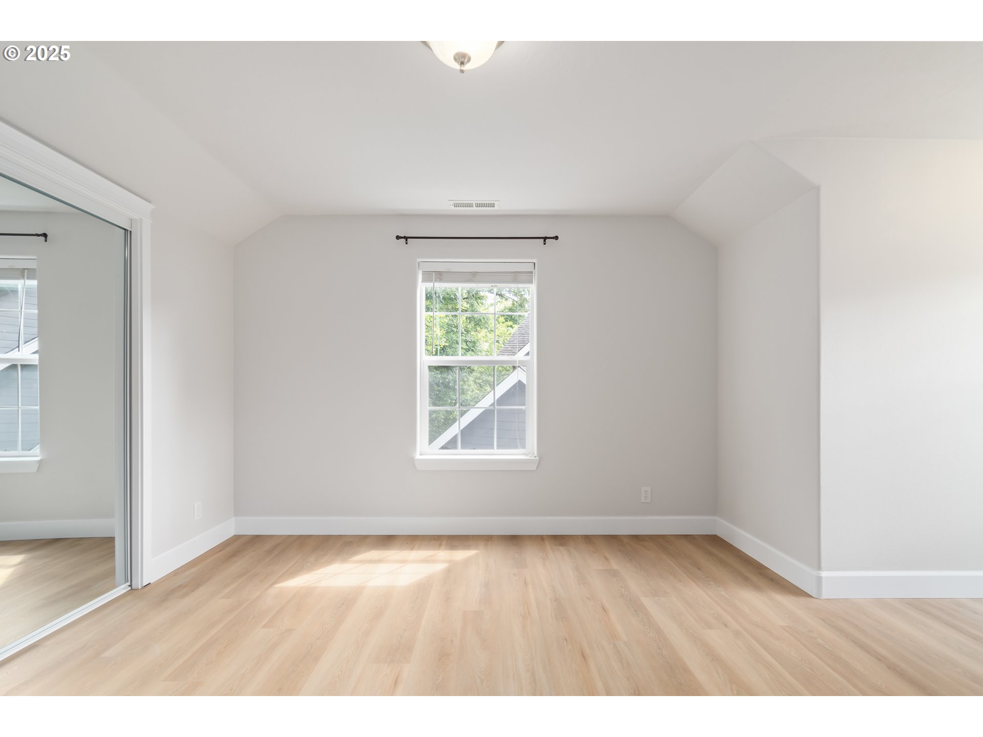 2795 Mallory Lane Eugene, OR 97401 - Photo 29 of 44 an empty room with wooden floor and windows