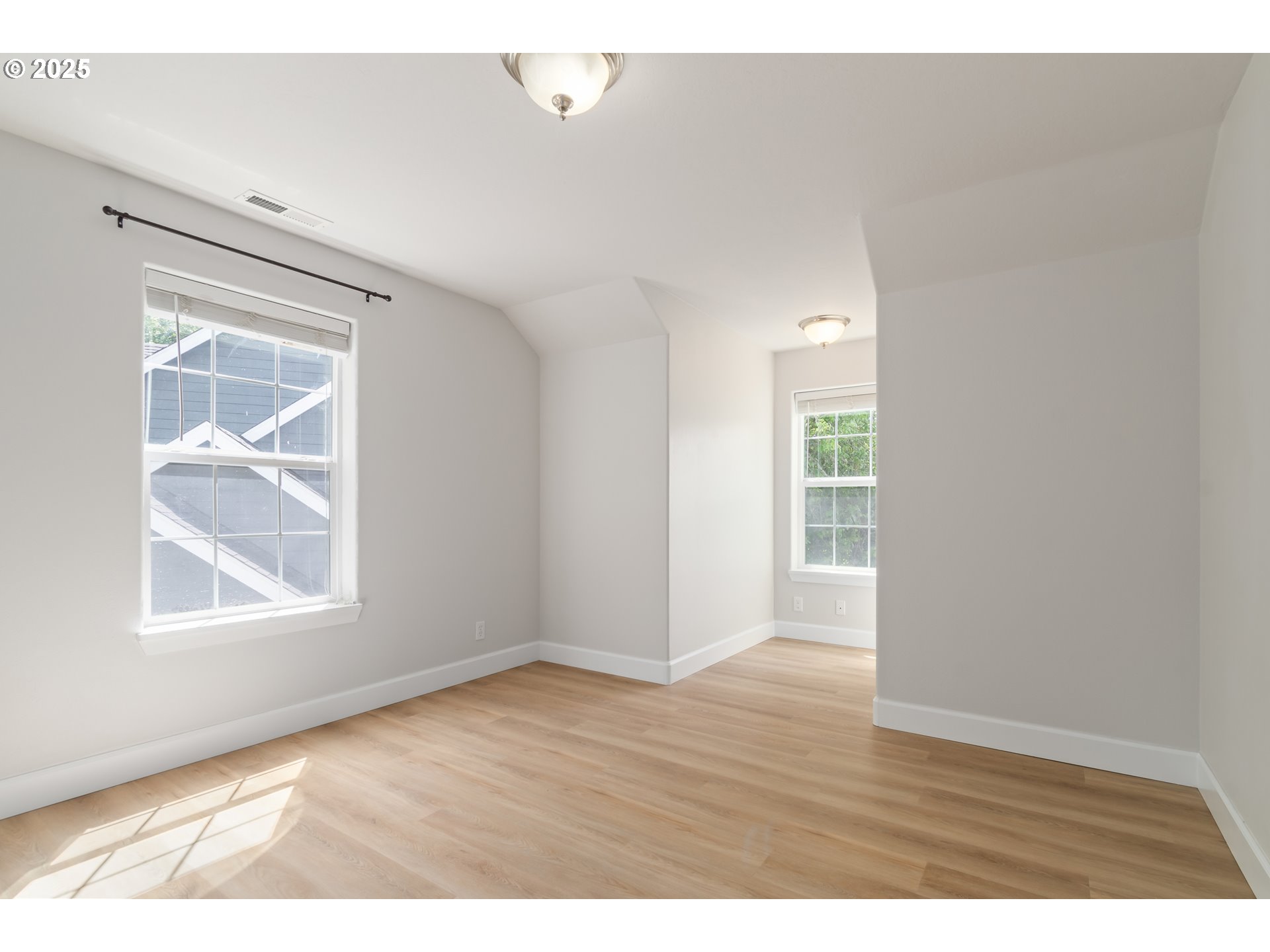 2795 Mallory Lane Eugene, OR 97401 - Photo 30 of 44 an empty room with wooden floor and windows