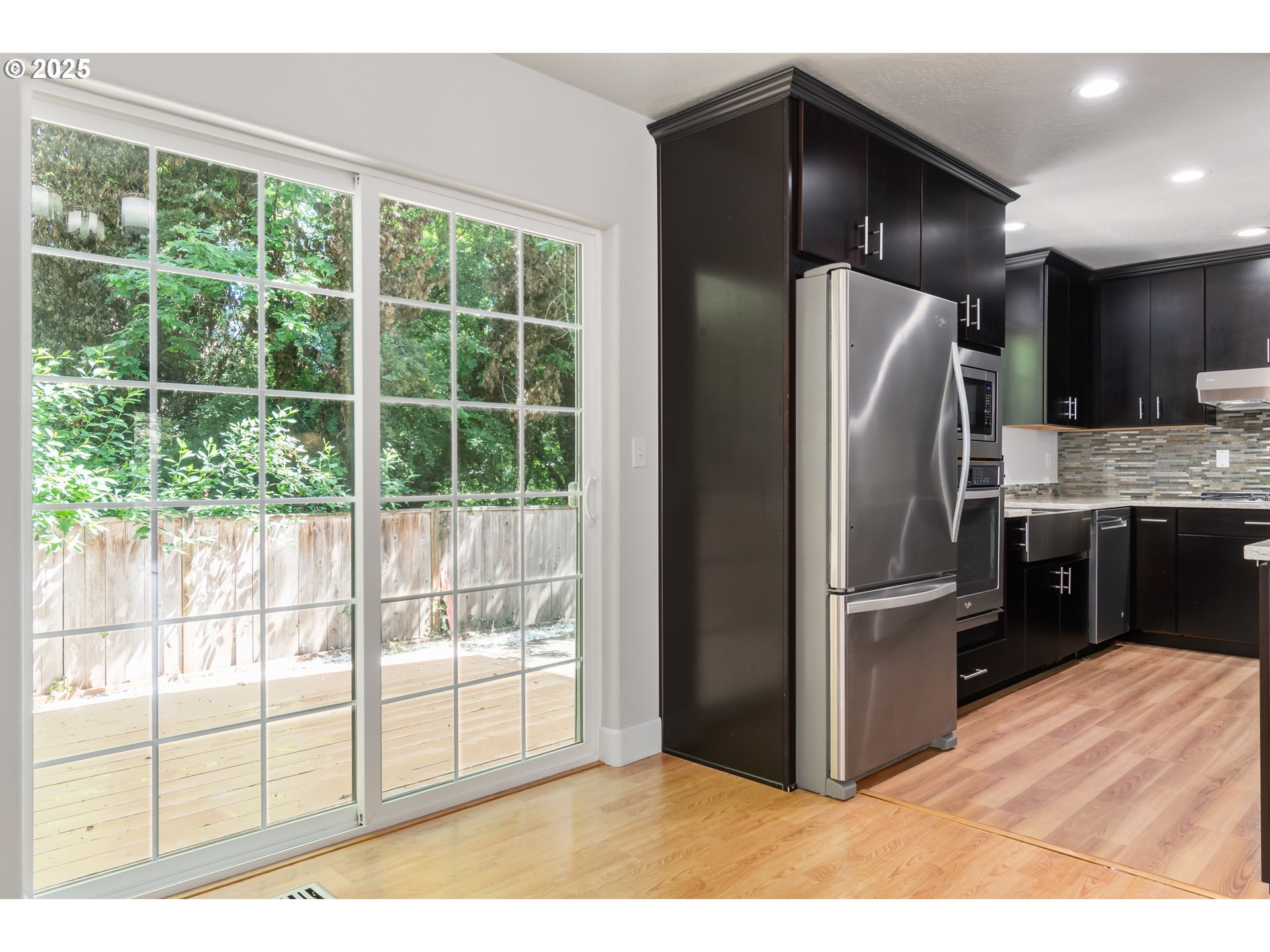 2795 Mallory Lane Eugene, OR 97401 - Photo 32 of 44 a kitchen with stainless steel appliances kitchen island granite countertop a refrigerator and a sink