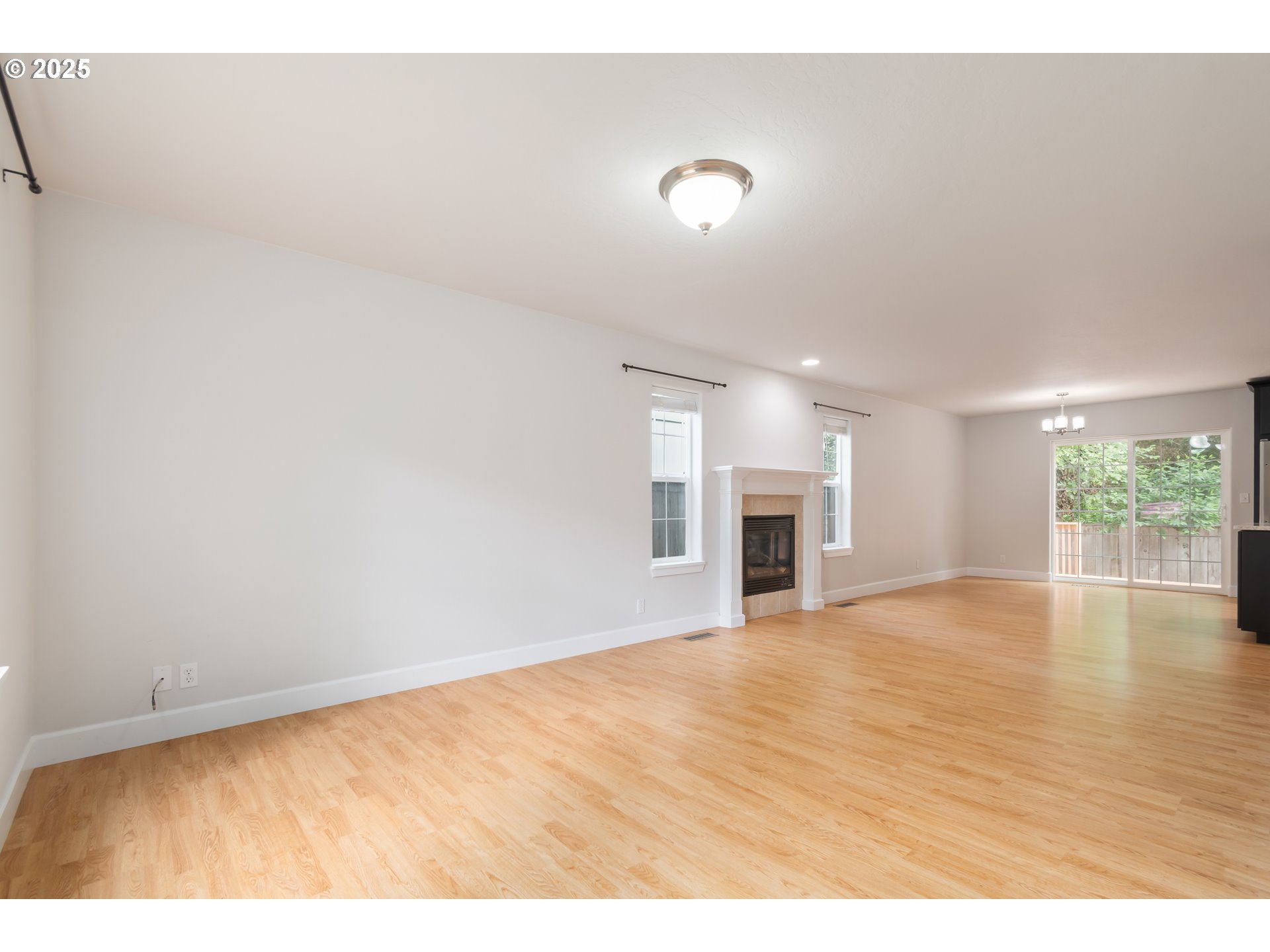 2795 Mallory Lane Eugene, OR 97401 - Photo 5 of 44 a view of an empty room with wooden floor and a window
