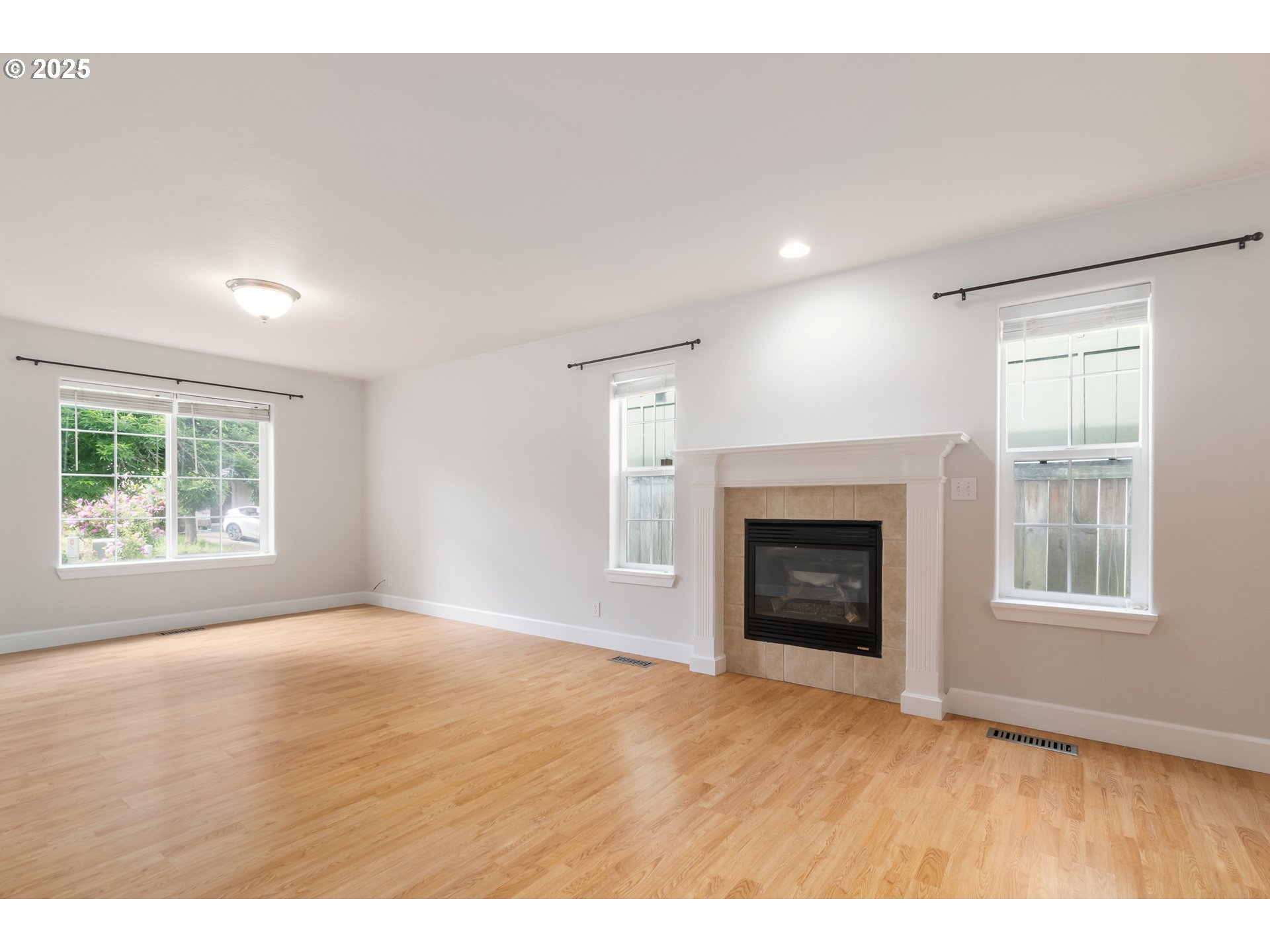 2795 Mallory Lane Eugene, OR 97401 - Photo 8 of 44 a view of an empty room with a window and fireplace
