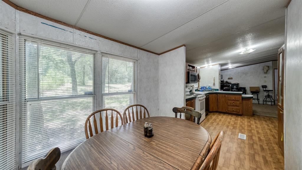 1700 Bennett Road Millsap, TX 76066 - Photo 11 of 40 a view of a dining room with furniture and wooden floor