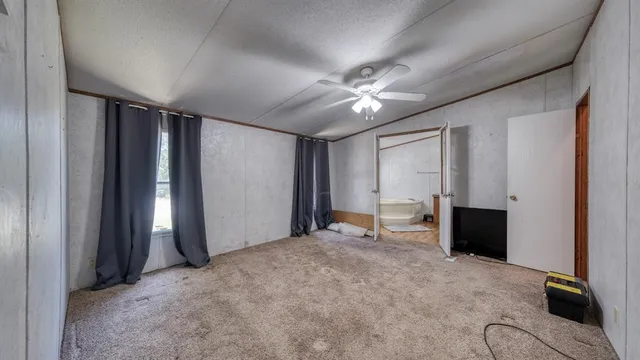 an empty room with windows and closet