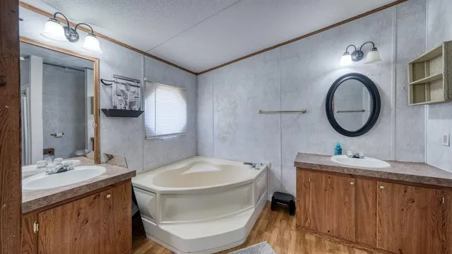 a bathroom with a granite countertop toilet a sink and a mirror