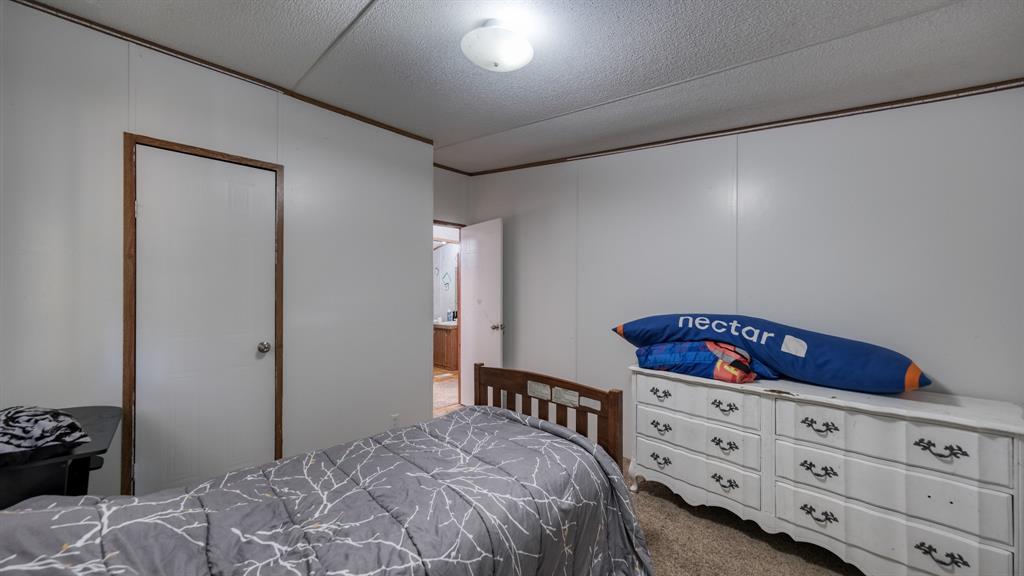 1700 Bennett Road Millsap, TX 76066 - Photo 23 of 40 a bedroom with a bed and a dresser