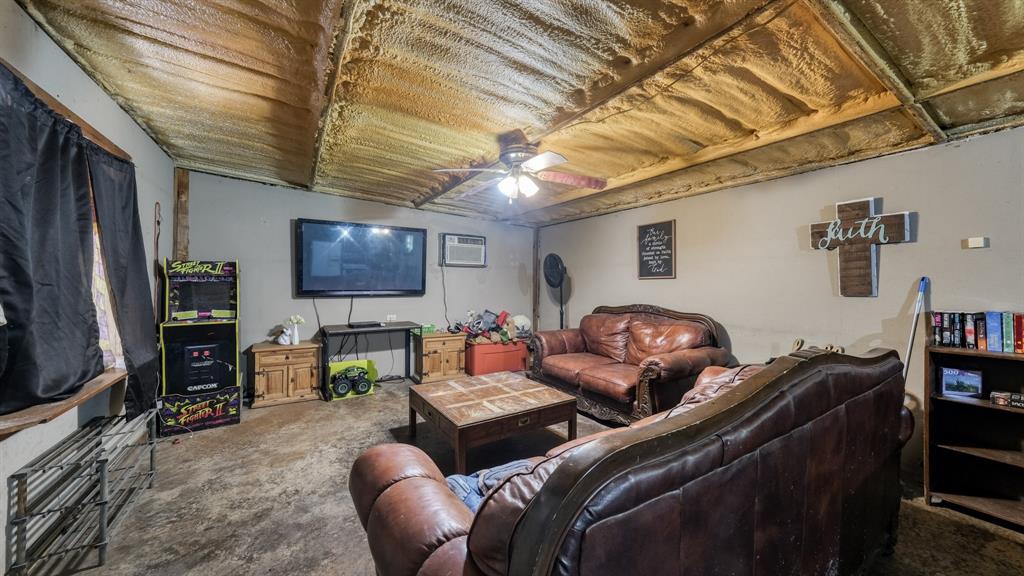 1700 Bennett Road Millsap, TX 76066 - Photo 25 of 40 a living room with furniture and a flat screen tv